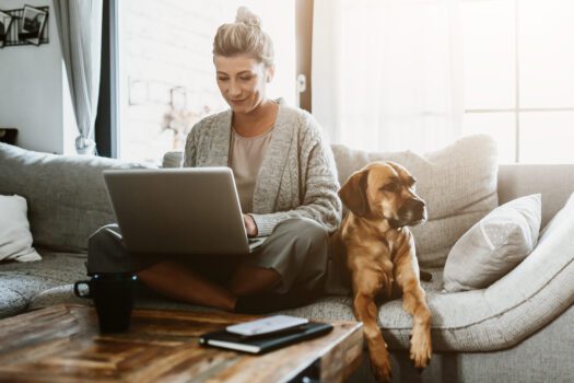 businesswoman-working-on-laptop-computer-sitting-at-home-with-a