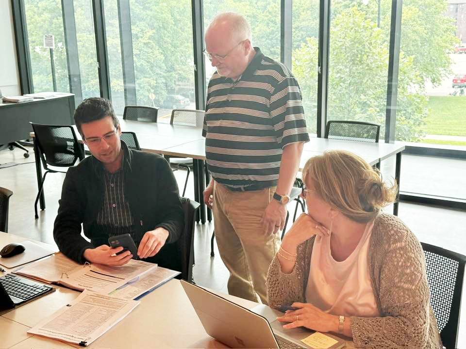 Reviewers discussing Federal Tax Workbook edits at August review meeting.